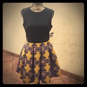 Black & mustard colored dress designed by Taylor